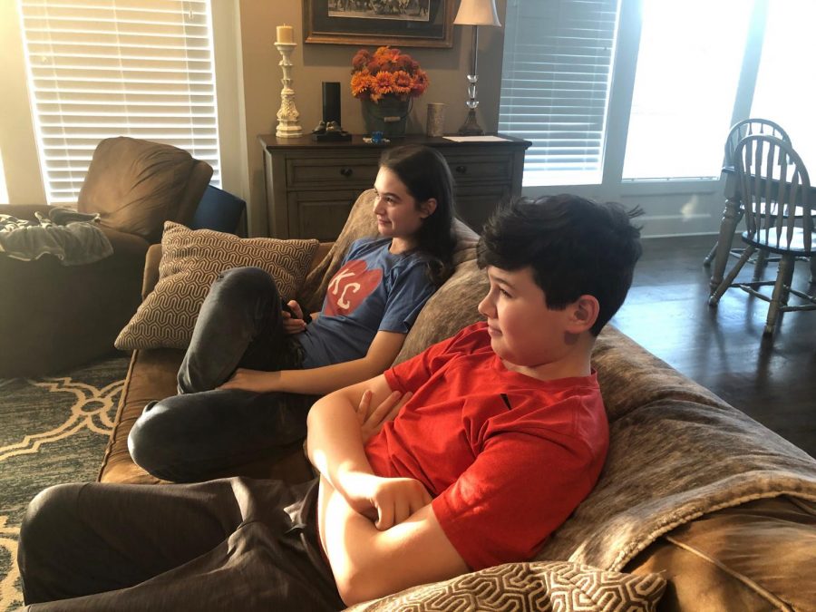 From the comfort of her own home, junior Taylor Doyle watches a show with her brother Thursday, Oct. 1.