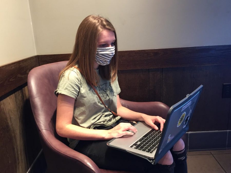 Using her laptop at a local Starbucks, senior Patty McClain engages with other applicants during a virtual college visit via Zoom on Thursday, Oct. 1