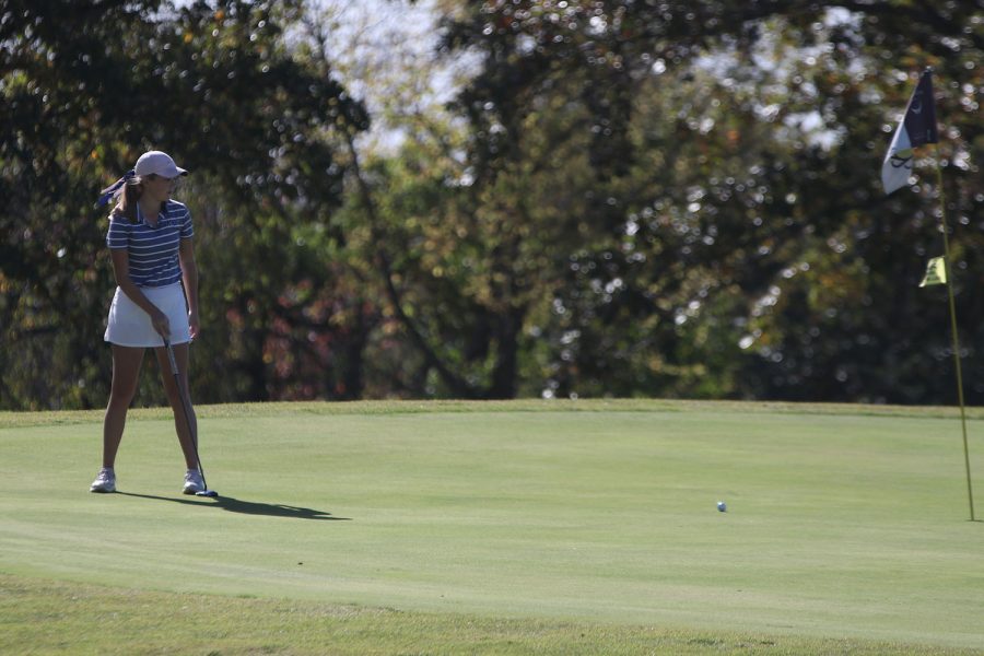 After hitting the ball, junior Charley Strahm watches it roll towards the hole.
