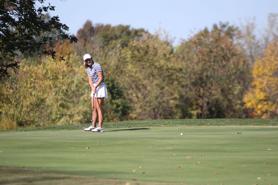 Eyes on the ball, junior Libby Green watches to see how well she hit the ball.
