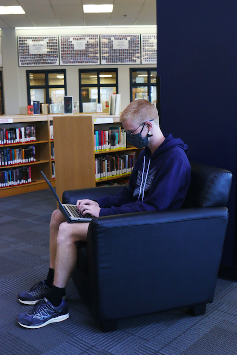 While proofreading the essay section of his application, senior John Lehan makes notes and leaves edits on his first draft of his essay on Monday, Oct. 12.