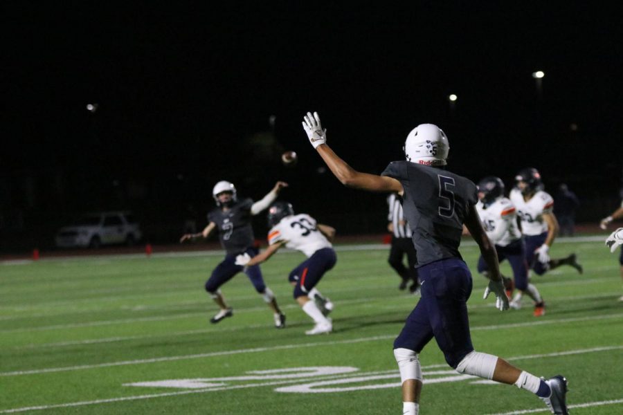 To help out quarterback Cooper Marsh, wide receiver Kendrick Jones puts his hand in the air to show he is open for the pass.