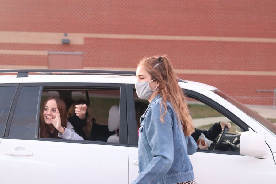 A car full of students drives away excited to start their morning off right with donuts. 