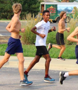 Smiling, freshman AJ Vega starts his mileage run with the boys cross country team Monday, Sept. 21