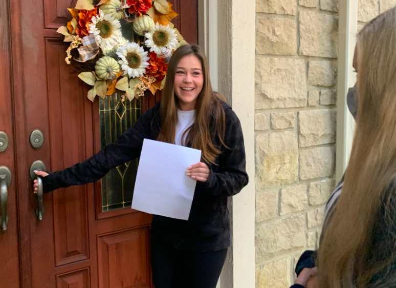 Outside her home, senior Delaney Fields is told she is a Homecoming candidate.