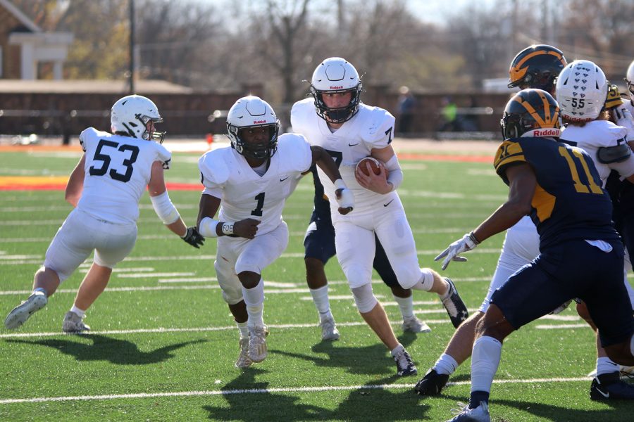 With running back Quin Wittenauer in front of him, quarterback Cooper Marsh carries the ball closer to the end zone.  