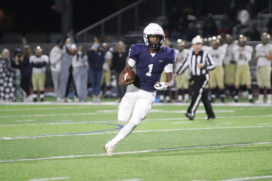 Running the ball, senior Quin Wittenauer makes his way down the field.
