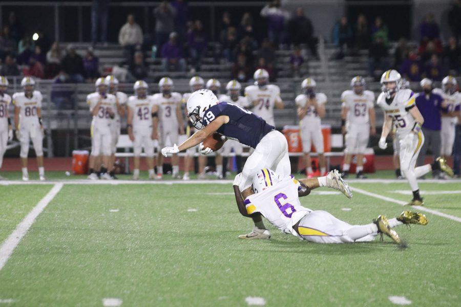 Diving, senior Ty Reishus gains yards before going down.
