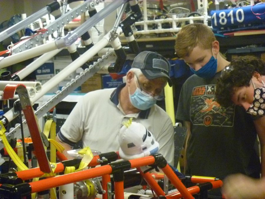 Lead robotics mentor Gary Hannah explain the teams robot to De Soto freshman Moses Morton. Thursday, Nov. 19