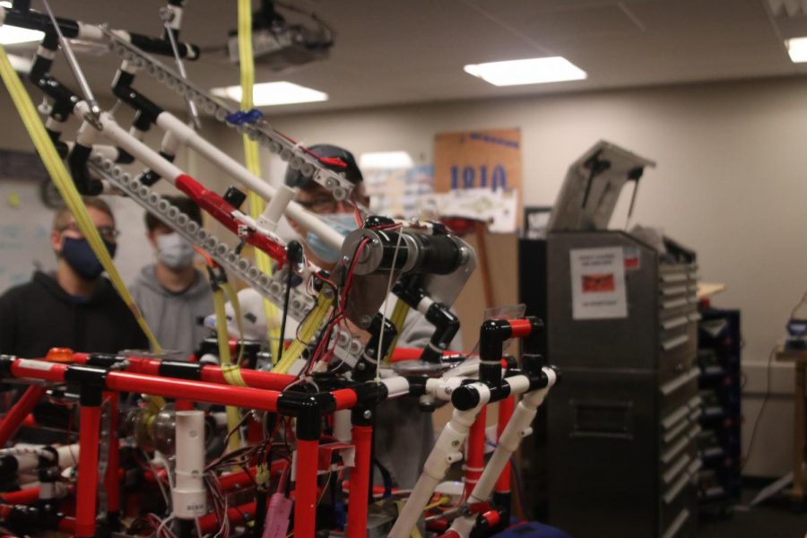 The robotics team observes their robot Thursday, Nov. 19