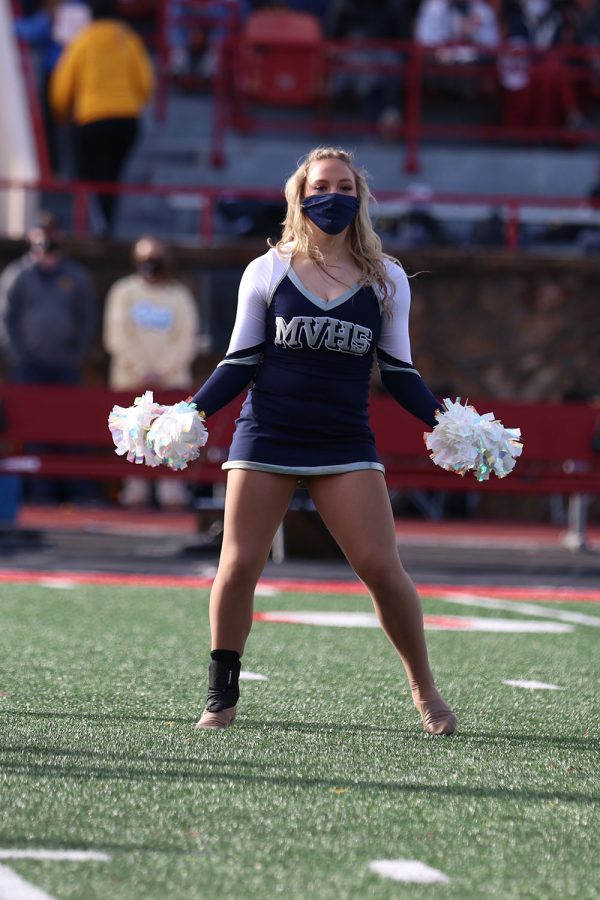 During the halftime show, freshman Trinity Baker shakes her poms to the music.
