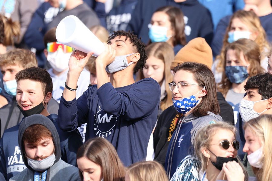 Excited, junior Adrian Dimond screams through his megaphone to cheer on the team.
