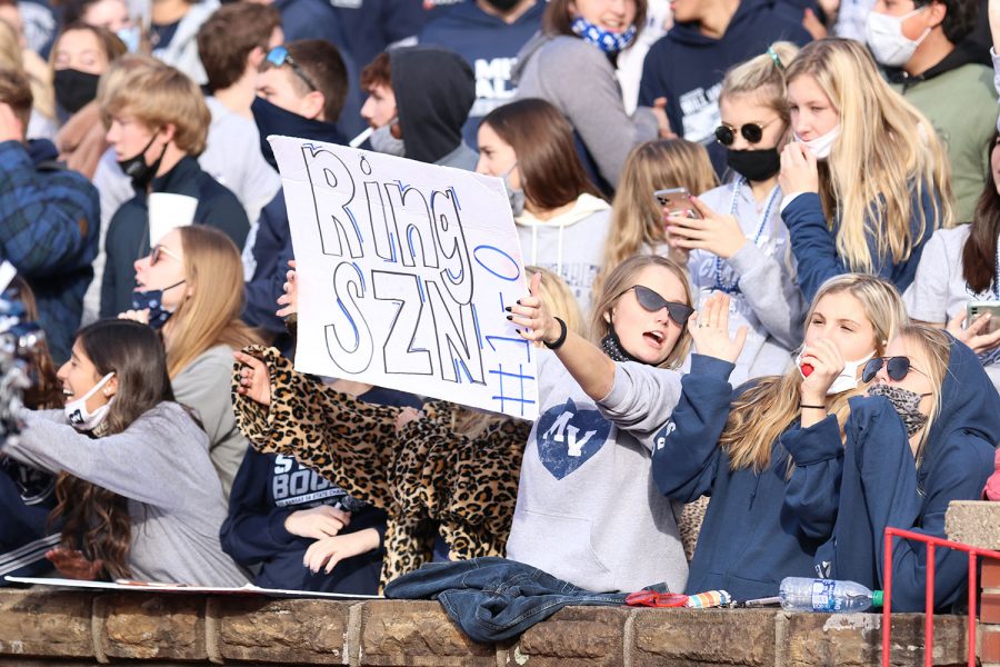 Sign up in the air, senior Callie Shryock cheers on the game.
