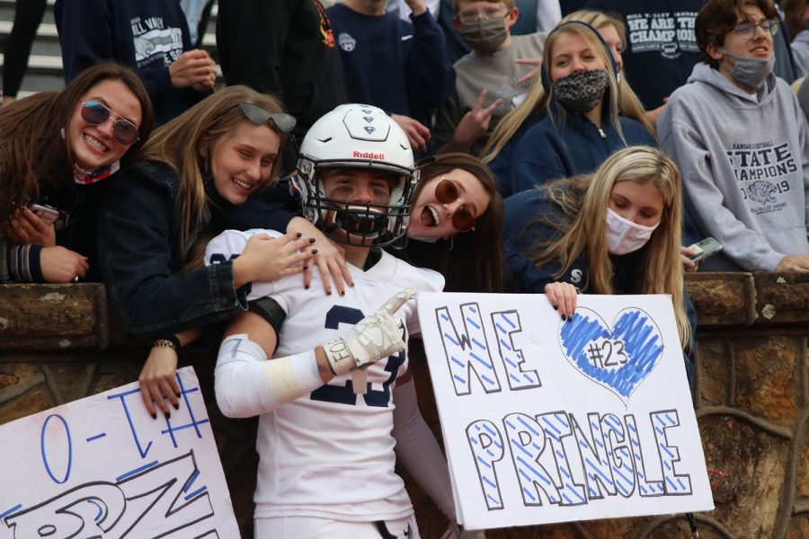 Posing with the crowd, defensive back Lucas Pringle takes a picture.

