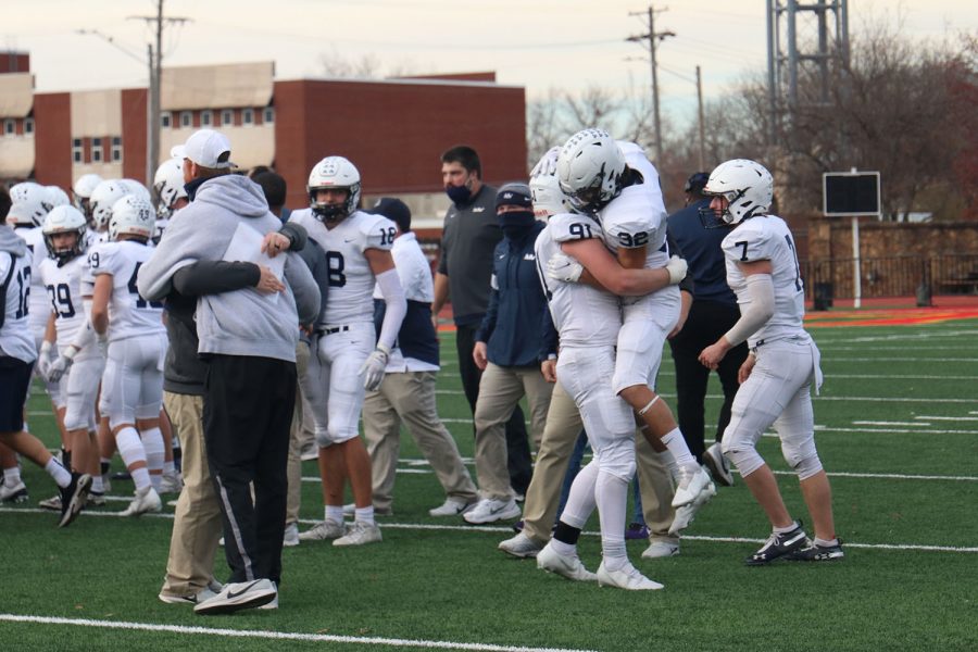 Team members celebrate after the whistle ended the game.