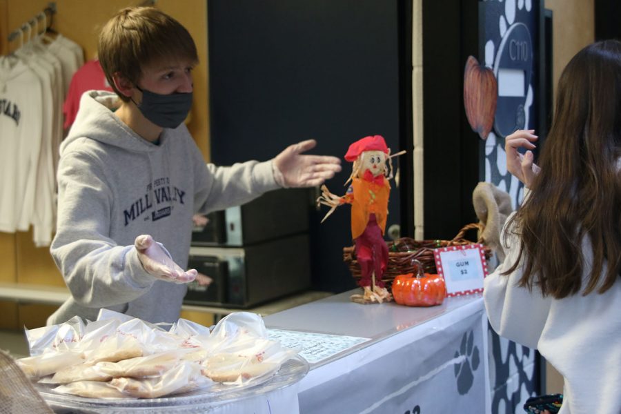 Working front desk is Kyle Moylan he is trying to sell cookies to the students at the opening of the Catty Shack.