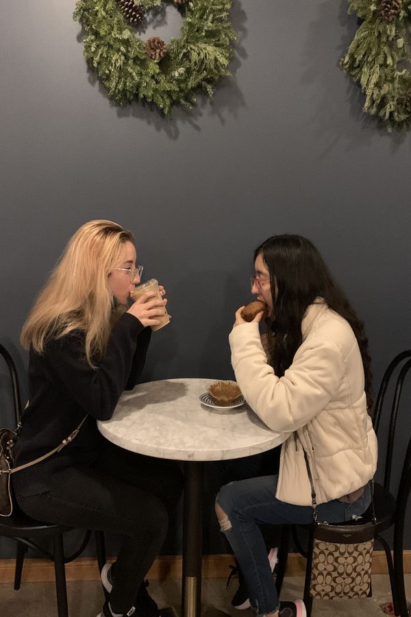 Hanging out, junior Natalia Hernandez has an iced latte and junior Dayanara Trevizo has a carrot muffin.
