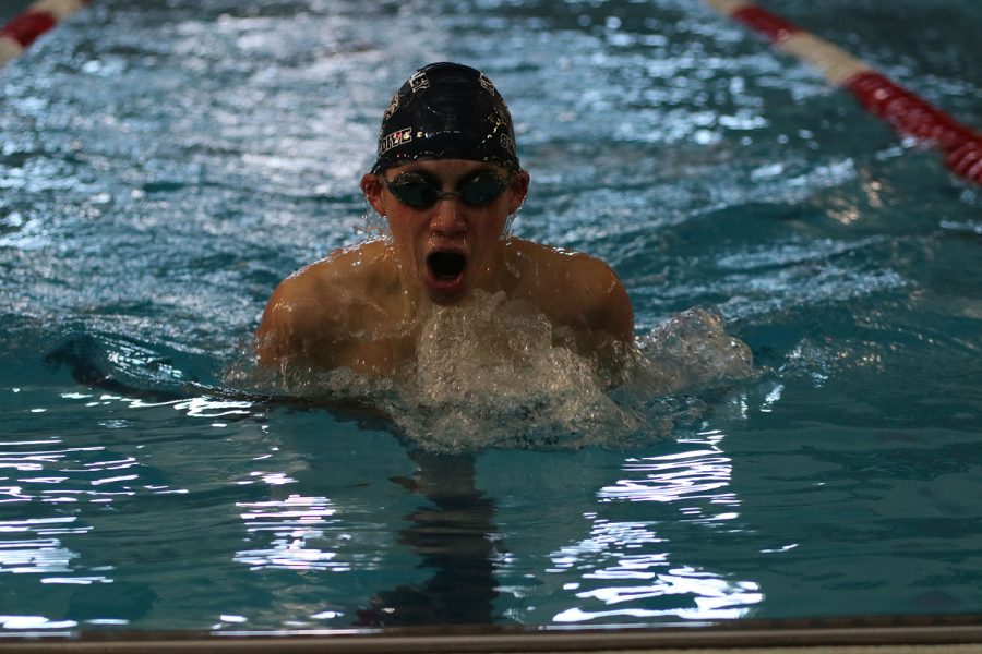 During his leg of the relay, freshman Andre Arnold takes a breath while swimming breaststroke Saturday, Dec. 5. 