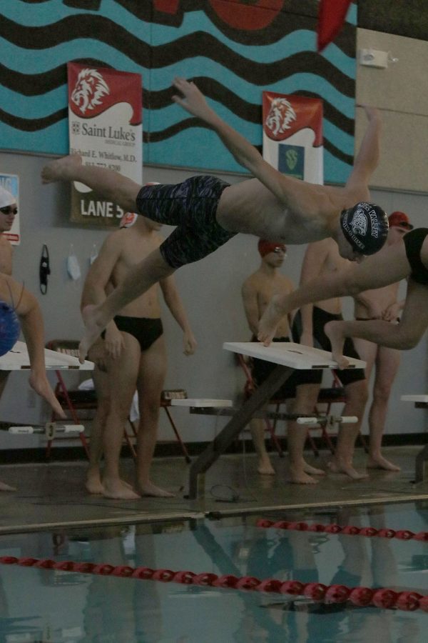 Diving off the block, sophomore Adam Budimlija begins his race at the Lansing Relays Saturday, Dec. 5. 