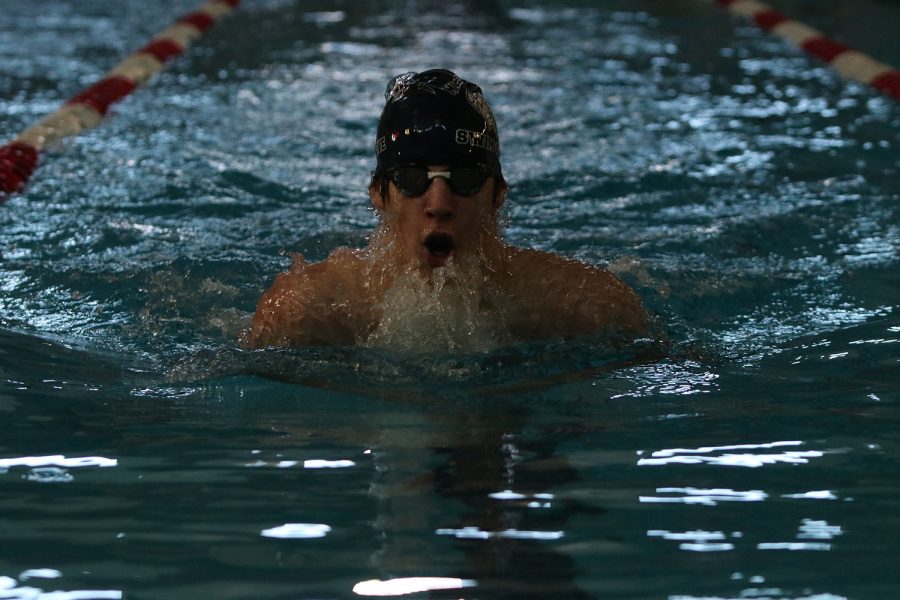 Swimming in the 200-yard breaststroke relay, sophomore Adam Budimlija competes at the Lansing Relays Saturday, Dec. 5. 