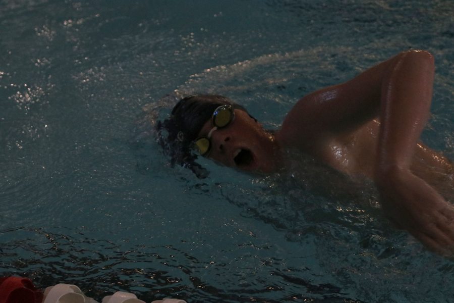 Arm above the water, freshman Gabe Budimlija swims freestyle at the Lansing Relays Saturday, Dec. 5. 