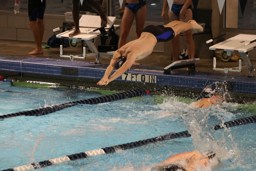 Diving in to start his portion of the relay, senior Mason Davis competes in the 200-yard freestyle relay. 