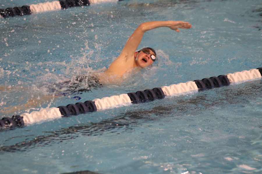 Taking a breath of air, freshman Andre Arnold continues his race in the 200-yard freestyle. 