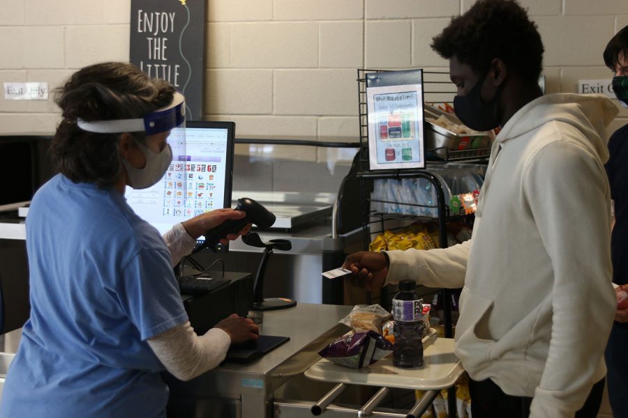 Rather than type in their lunch code, students were given lunch cards this year to help limit the spread of COVID. During lunch, freshman Nate Carter’s lunch card is scanned on Monday, Nov. 16.