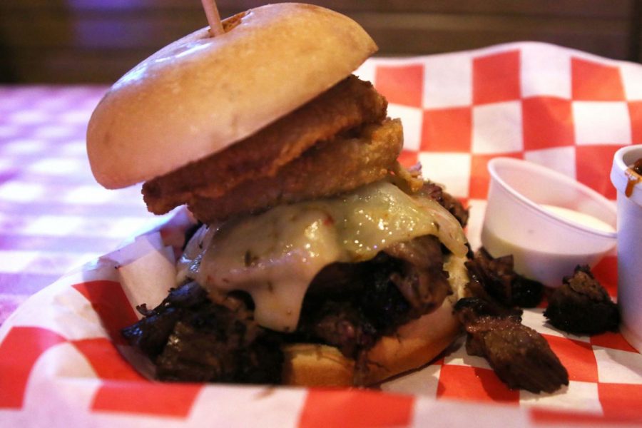 The Royal is a specialty dish that consists of burnt ends, onion rings and a slice of cheese on a burger bun. This dish comes with two sides.
