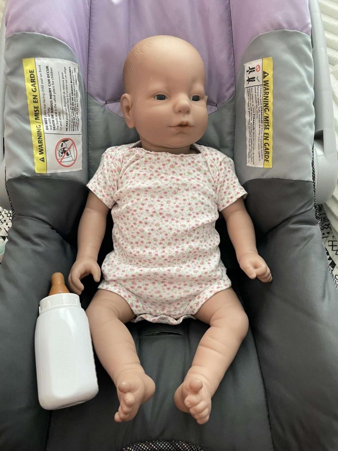 Sophomore Anna Stottlemyre takes a picture of her baby while returning home from picking it up. 

