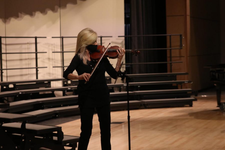 Violinist Christy Kumzitch performs a medley of common Christmas carols to separate each choir group performing as a duet with school pianist Cynthia Rodes.