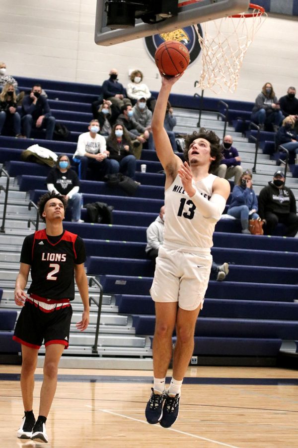 With the basket wide open, senior Pete Janssen makes a layup.