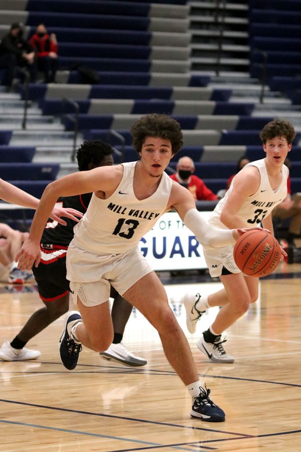 With a few minutes left in the fourth quarter, senior Pete Janssen dribbles the ball to the basket in an effort to score a few more points. 