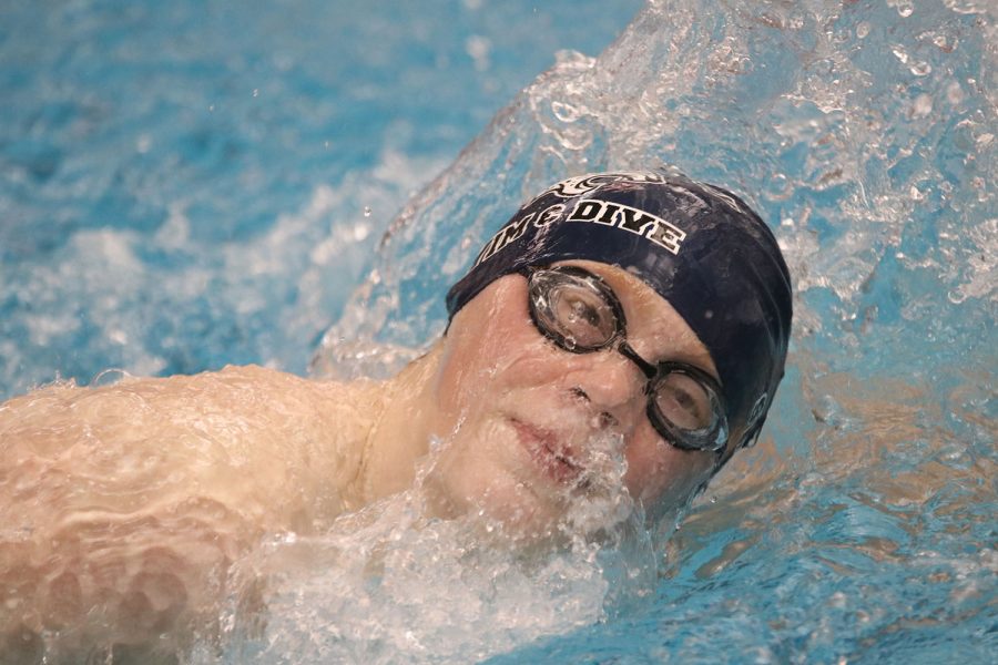 Breaking through the water, freshman Gabe Budimlija takes a breath while swimming freestyle.