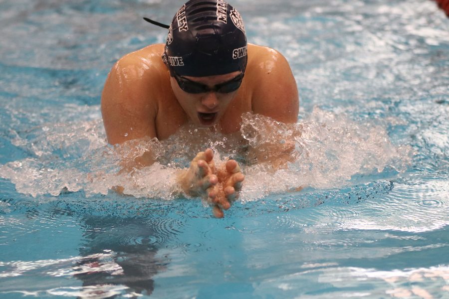 Coming up for air, senior Noah Collins swims the breaststroke portion of the 200-yard individual medley. 