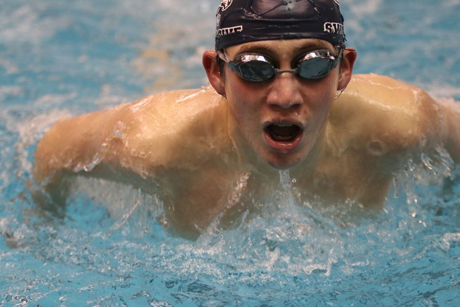 Arms extended, freshman Andre Arnold competes in the 100-yard butterfly with a time of 1:16.94. 