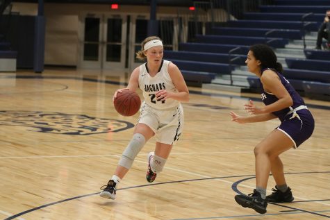 Driving down the court, junior Emree Zars competes against Piper high school Thursday, Jan. 14. The team fell to Piper in the end with a score of 48-25.  