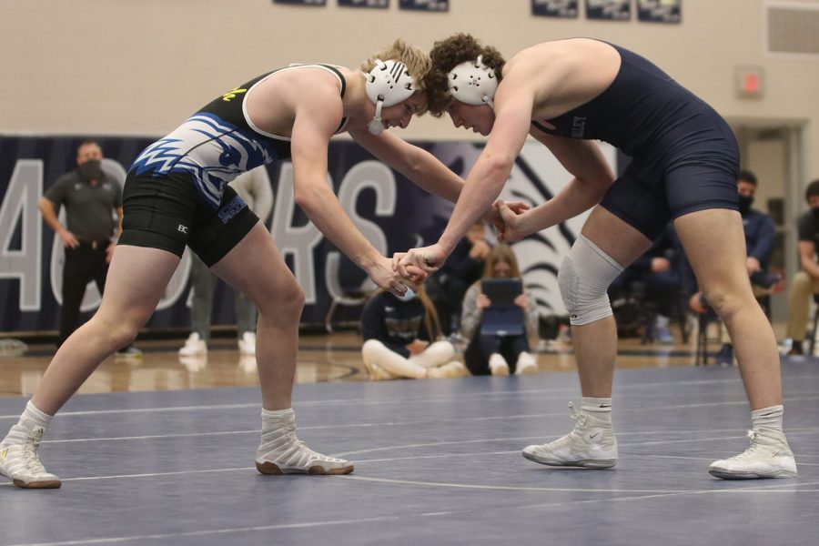 Head to head with his opponent, senior Brodie Scott begins his wrestling match during senior night Wednesday, Jan. 20. The six seniors on the team were honored for their contribution to the wrestling team. The team beat Olathe South 48-36.