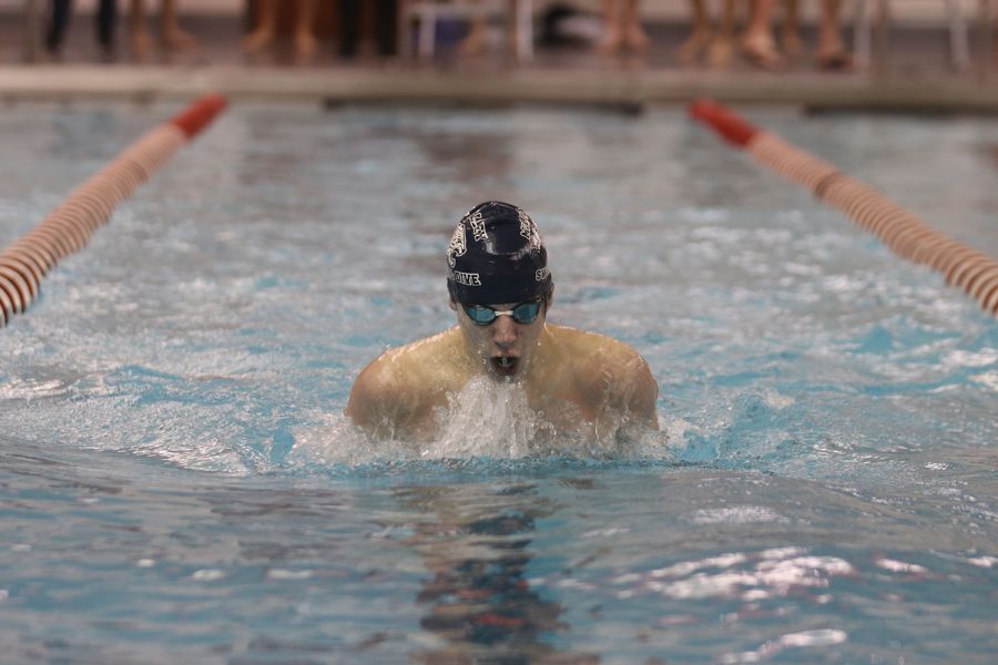 Nearing the wall, sophomore Adam Budimlija finishes his swim.

