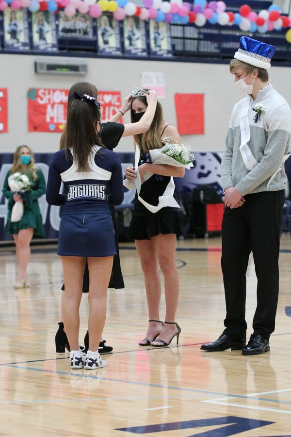 While a crown is placed on her head, senior Jaden Ravnsborg accepts the title as this years winter homecoming queen.