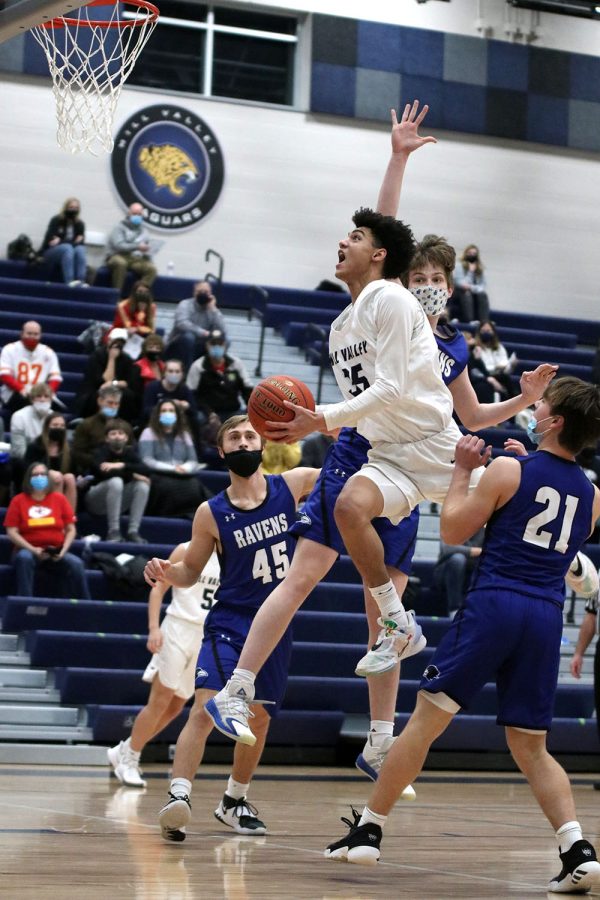 With his eyes on the basket, junior Adrian Dimond scores in the first quarter of the game.