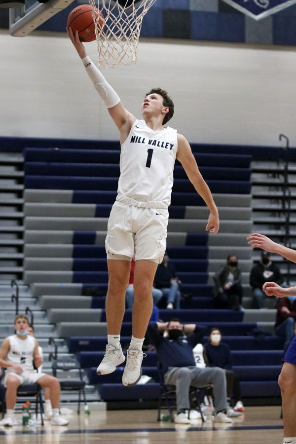 With the basket wide open, senior Nick Mason reaches for the backboard to make an easy layup.