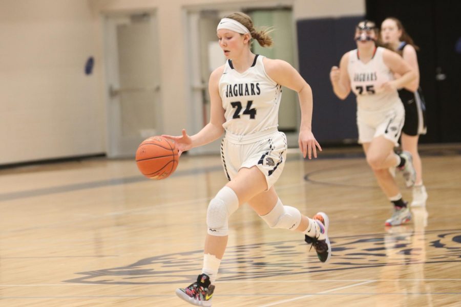 Running with the ball junior Emree Zars dribbles down the court. 