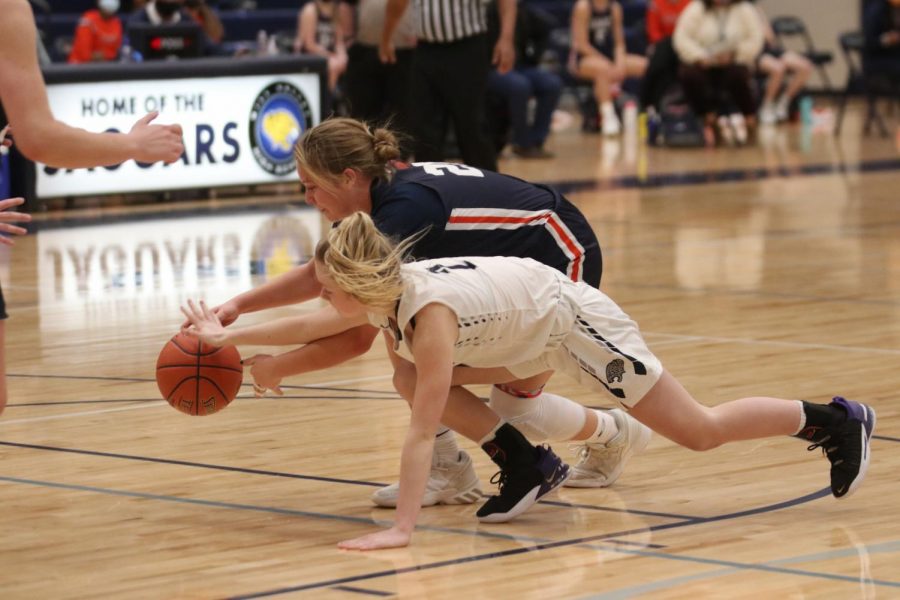 Arm stretched out, freshmen Keira Franken reaches for the ball before her opponent. 