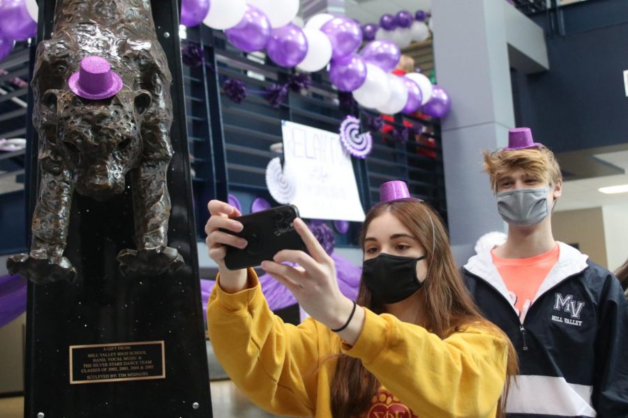 Taking a selfie, Senior Ellie Boone and junior Bret Weber smile at the camera under their masks at the Relay for Life purple bomb on Monday, Jan. 25.