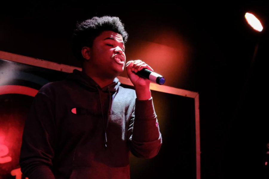 Rapping into the microphone on stage, junior Drew Morgan, also known as Lil Paula, performs at The Roxy in January of 2020.