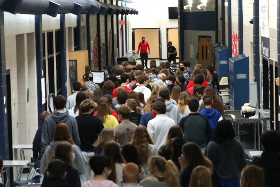 A fourth of the schools students are forced to cram into a single double door to collect their lunches.