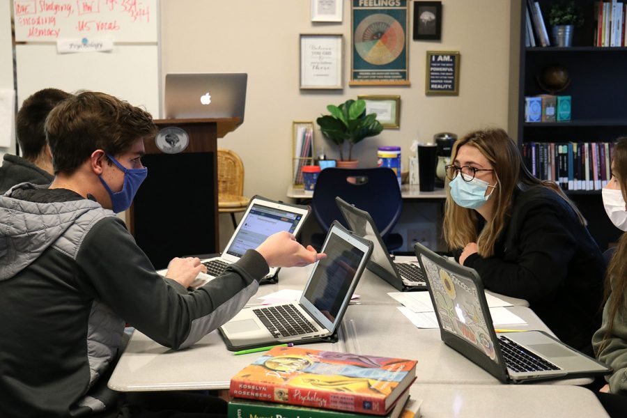 Talking with one another, seniors Kendall France and Alex Conan discuss their answers in newlygroup tables during AP Psychology Friday, Feb. 19.