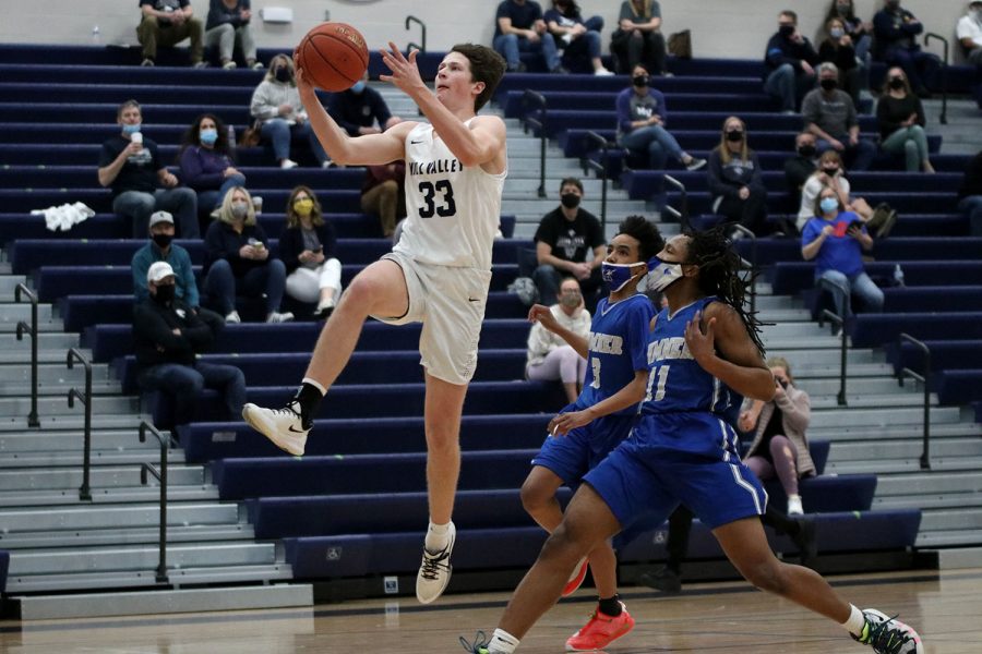 After stealing the ball from Sumner Academy, sophomore Dylan Blazer jumps up in the air with the ball to make the shot Wednesday, March 3. 