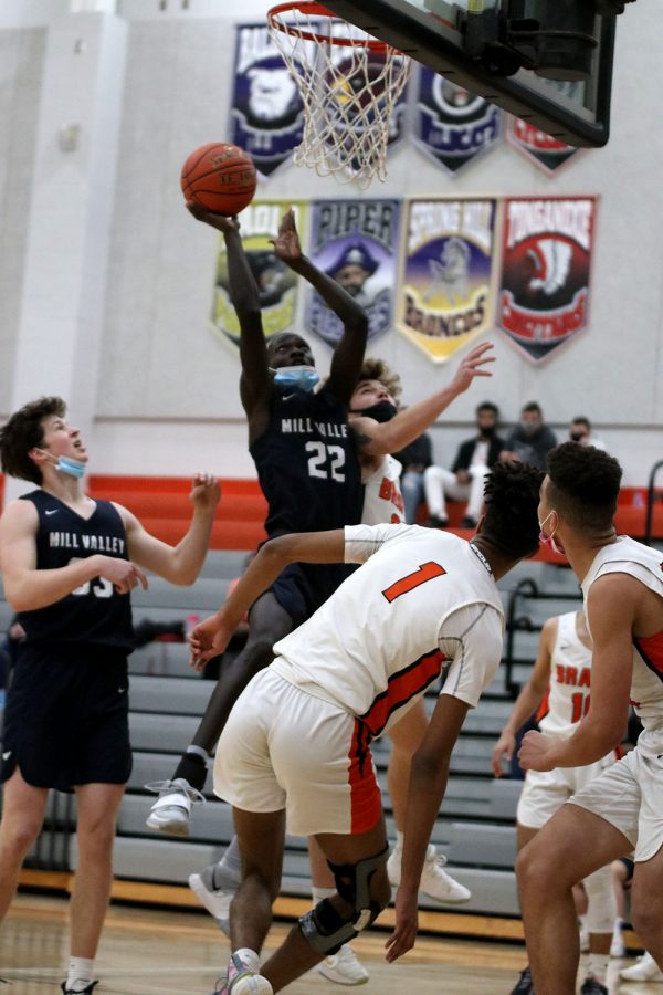 Before making the shot, sophomore Nen Matlock jumps up in the air towards the basket with the ball in his hand. 